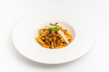 Top view of penne bolognese pasta in white plate on wooden table