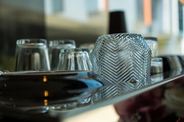 Selective focus of clean glass lie upside down on a coffee machine.