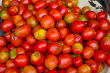 A vibrant assortment of fresh, ripe tomatoes in various shades of red. These nutritious vegetables convey freshness and are perfect for culinary uses such as salads, sauces, and other dishes.