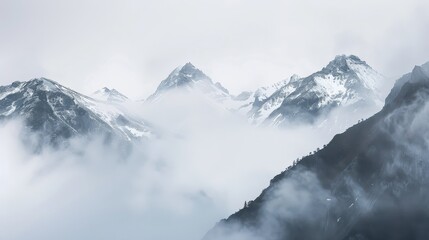 Fototapeta premium Misty Mountains with Snow-Capped Peaks Showcasing Nature's Tranquility