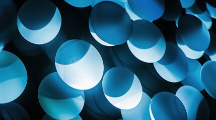 Abstract blue circles create captivating visuals with dramatic backlighting.