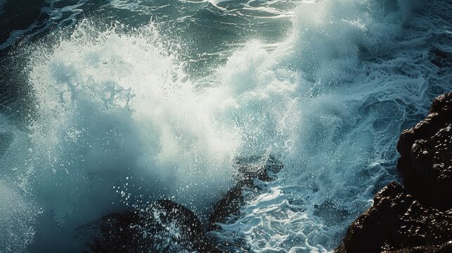 Powerful ocean waves crashing against rocky shore in dramatic scene