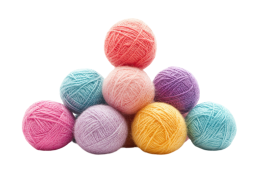 Colorful yarn balls stacked in a creative arrangement at a crafting workspace