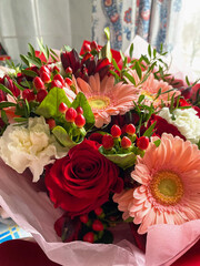 Vertical picture, a bouquet of assorted flowers stands in a vase
