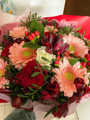 Vertical picture, a gorgeous bouquet of flowers in a man's hand