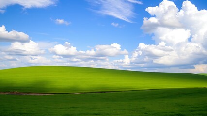 Obraz premium Serene landscape featuring a lush green rolling hill under a vivid blue sky adorned with fluffy white clouds, ideal for nature-themed designs.