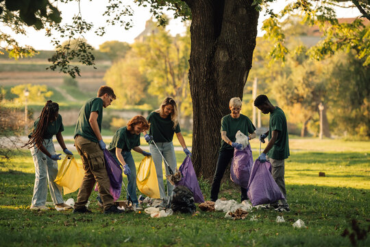 Group of volunteers collecting garbage in park