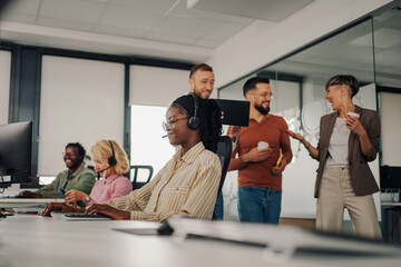 Customer service representatives working in busy modern office