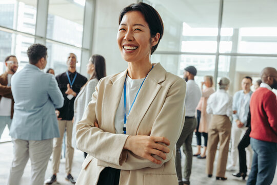 Happy Korean businesswoman networking at a conference event