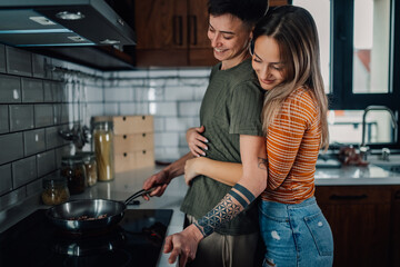 Lesbian couple cooking together in modern kitchen