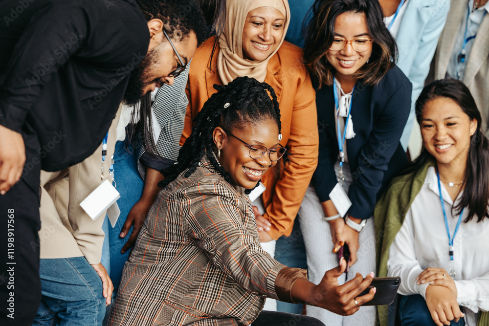 Wall mural multiethnic team posing for a photo with smiles and camaraderie in a dynamic workplace setting