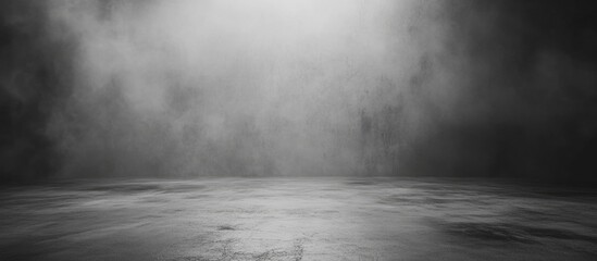 Dark dramatic foggy background with light rays illuminating a textured surface and ample copy space for text placement