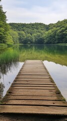 Obraz premium Wooden Pier Over a Calm Lake Surrounded by Lush Green Forest