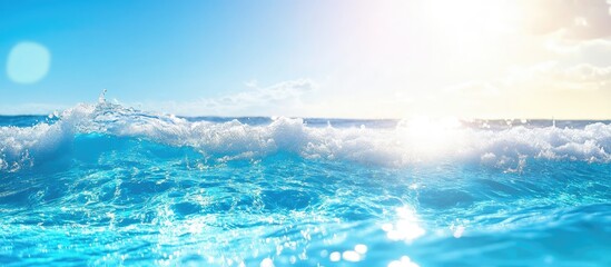Bright sunlight reflecting on clear ocean waters with waves under a blue sky and copy space for text.