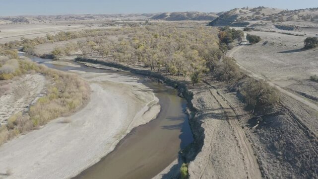 4K flight over the Salinas River as it winds it's way past the town of Bradley California with the 101 highway in the upper right of frame.