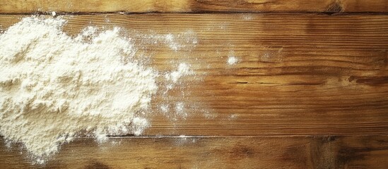 Flour spread on rustic wooden table with copy space for culinary or baking related themes