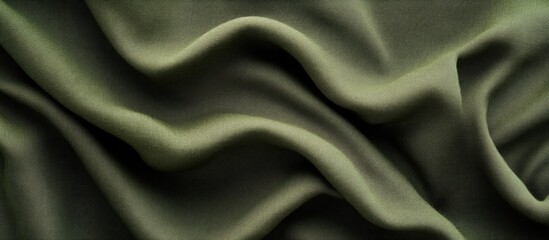 Fototapeta premium Green fabric texture with folds and creases showcasing smooth and soft material suitable for background use with copy space.