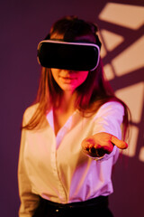 Engaging in a digital adventure, a woman explores virtual reality with immersive headset and...