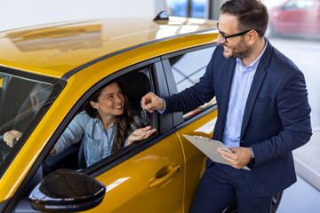 Car Renting Service. Young Woman Driver Taking Keys From Manager While Sitting In Rental Auto, Smiling woman Enjoying Vehicle Leasing, Cropped Image, Closeup