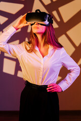 Woman exploring virtual reality with VR glasses in a vibrant digital environment