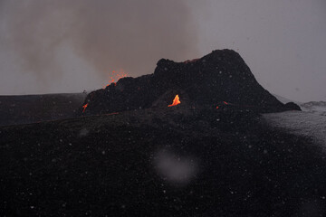 Iceland volcano erupting in snow storm with heavy snowfall, fantastic image with incredible...
