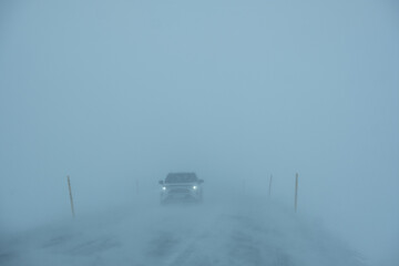 Car driving in a snowstorm