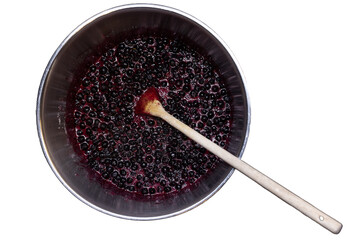 Isolated pot with blueberries when making blueberry jam