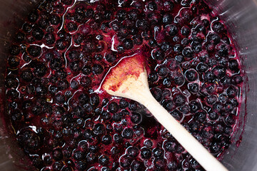 Boiling blueberries to make blueberry jam