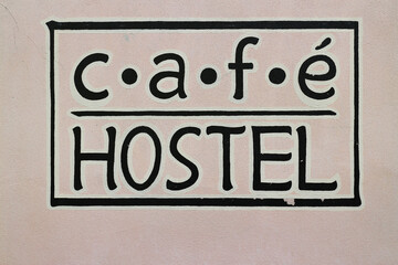 Sign for a cafe and a hostel