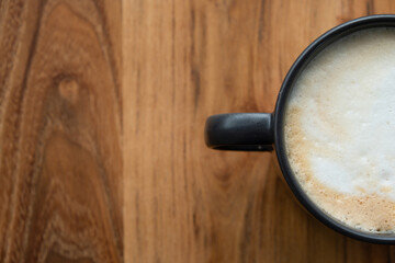 Coffee mug on wooden table with copy space