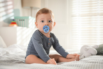 Fototapeta premium Cute little baby on bed at home