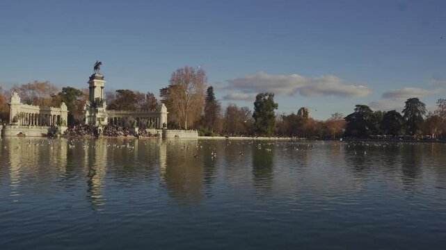 Amazing view of the Buen Retiro park from the lake at the sunset