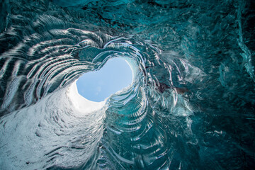 Blue sky visible from a hole inside an icecave in Iceland