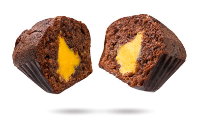 Chocolate muffin cut in half flies close-up on white. Isolated