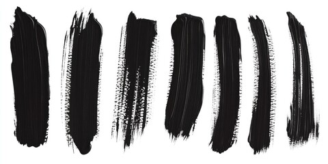 A close-up shot of various black brush strokes on a white background