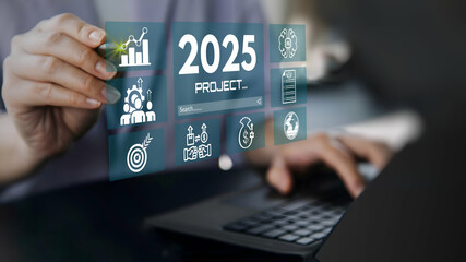 A businessman using laptop with Business plan strategy marketing and finance to goal in 2025. planning business growth with technology AI.