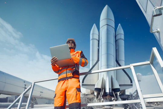 Professional engineer working in rocket lunch pad with laptop for control operate spaceship liftoff
