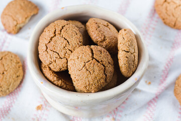 A bowl full of gluten-free homemade oatmeal cookies in close-up. Shallow depth of field..