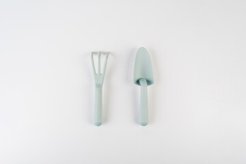 Garden tools with blue grips on a white background