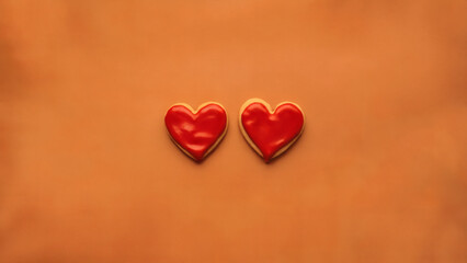 Fototapeta premium Icing cookies: A simple yet striking photo of two red heart-shaped icing cookies placed side by side