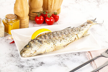 Grilled sea bass fish served lemon