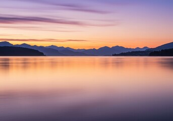Tranquil mountain lake at sunset with vibrant sky reflection
