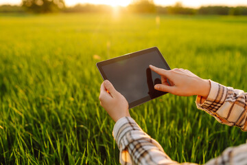 Farmers use agricultural technology in data analysis tablets. Women use tablets to research and...