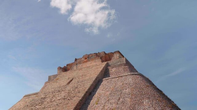 Pyramid of the Magician piramide del adivino with cloud on top at Uxmal mayan site Yucatan Merida