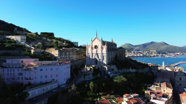 Aerial pullback orbit of Tempio di San Francesco Gaeta, Lazio, scenic coastal landscapes and historic architecture in Italy