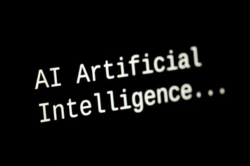 Black computer screen, with the text AI Artificial Intelligence. Use and evolution of artificial intelligence.