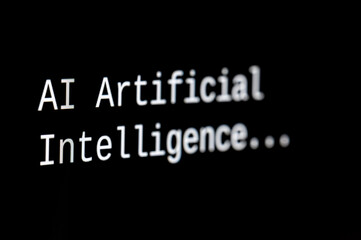 Black computer screen, with the text AI Artificial Intelligence. Use and evolution of artificial...