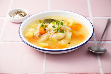 Clear soup with white fish and vegetables
