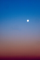 Early morning with moon in blue sky