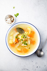 Clear soup with white fish and vegetables
